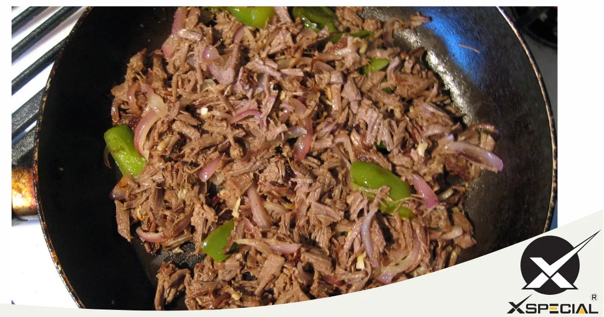 A frying pan with blade meat tenderizers and steak on it.